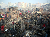 Bangladeshi Slum dwellers seen searching for their household belongings after a devastating fire that broke out at Chalantika slum last nigh...