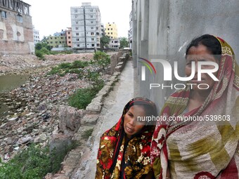 Dhaka 22 April 2015. Two women visit the site of the Rana Plaza building ruins in search of a lost loved one. Thousands of mourners commemor...
