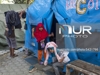 Disaster survivors play in front of their makeshift tents at the Agung Mosque shelter in Palu, Central Sulawesi, Indonesia on February 13, 2...