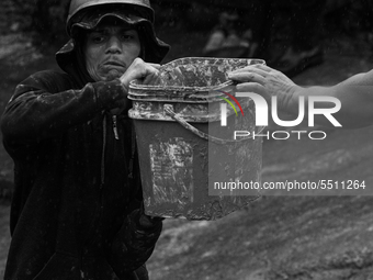 (EDITOR'S NOTE: Image was converted to black and white) The residents of the community and the fire department work together to clear de rub...