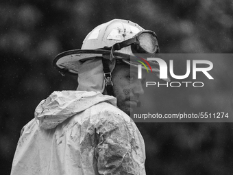 (EDITOR'S NOTE: Image was converted to black and white) The residents of the community and the fire department work together to clear de rub...