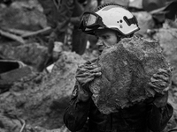 (EDITOR'S NOTE: Image was converted to black and white) A fireworker work to clear de rubble after the collapse that took place during the l...