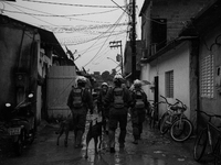 (EDITOR'S NOTE: Image was converted to black and white) Military fire brigade and sniffer dogs walk through the alleys after the collapse th...
