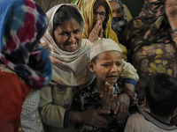 Family members of Bhure Ali wail during his funeral in Mustafabad area of east Delhi, India on 04 March 2020. Ali, a labourer left home on 2...