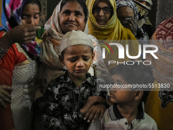 Children wail near the deadbody of Bhure Ali during his funeral in Mustafabad area of east Delhi, India on 04 March 2020. Ali, a labourer le...