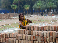 Bangladeshi woman daily labor works in a contraction site in Dhaka, Bangladesh, on March 7, 2020. Each woman labor earn 4.71 US dollar or 40...