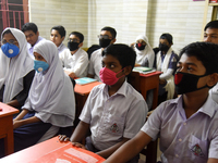 Bangladeshi Students wearing facemasks in their school as a preventive measure against the spread of the COVID-19 coronavirus outbreak, in D...