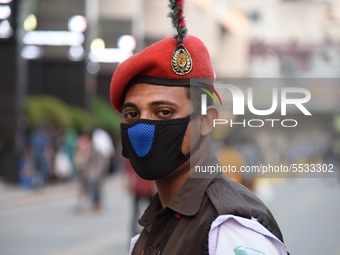 A Bangladeshi security person wearing facemasks during duty on the street as a preventive measure against the spread of the COVID-19 coronav...