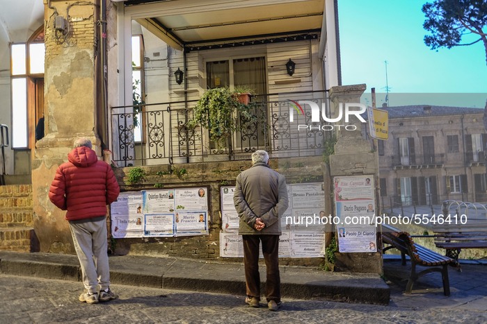 Two man reading the funerals notice in Lanciano, Italy, on March 14, 2020. (Photo by Federica Roselli/NurPhoto)