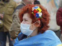 A woman wearing protective mask participates at a rally called 'March of Patriots' at the Volunteer Day in honor of volonteer fighters who j...