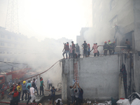 Firefighters, volunteers work to douse a fire at a ready-made garment (RMG) factory in Dhaka, Bangladesh on March 14, 2020.  (