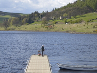 A person, engaged in the sport and recrational activity of angling on Ladybower Reservoir, in the Peak District National Park on Wednesday 2...