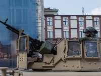 Armored car HMMWV with the soldiers of the Security Service of Ukraine on the background of the opera house In the days of the anniversary e...