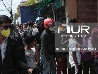 People stand in queue outside a medical store to buy face masks amid concerns about the spread of coronavirus, COVID-19 disease outbreak, in...