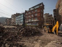 A backhoe loader remove the rubble caused by the collapse of a building on the Ring Road at the Balaju District of Kathmandu.
The death tol...