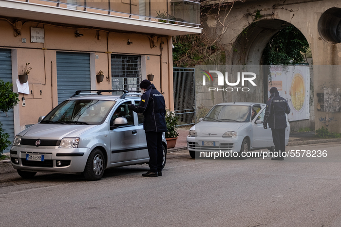Municipal police control movement on a main entrance to the city of Lanciano, Abruzzo, Italy, on March 23, 2020 to efforts to curb the sprea...