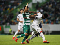 Sporting's Colombian forward Fredy Montero (L) vies with Nacional's defender Zainadine Junior during the Portuguese League football match be...