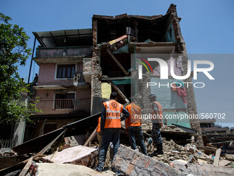 India rescue team seeking the bodies of a woman inside the rubble of this collapsed house in the small village of Sankhu outside Kathmandu....