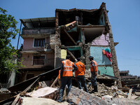 India rescue team seeking the bodies of a woman inside the rubble of this collapsed house in the small village of Sankhu outside Kathmandu....