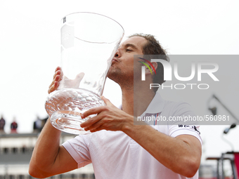 French tennis player Richard Gasquet kisses his trophy during the award cerimony after winning the Portugal Open tennis tournament in Estori...
