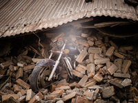 A motorbike burried beneath rubble following the 2015 Nepal earthquake, Kathmandu Durbar Square, Kathmandu, Nepal. An earthquake with a magn...