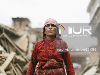 A Nepalese woman waling down a street of buildings destroyed by the 2015 Nepal earthquake, Durbar Square, Bhaktapur, Nepal. An earthquake wi...