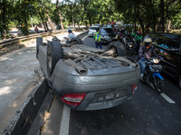 The badly damaged Mercedes in single accident is lying on the roof in Jakarta, Indonesia on April 22, 2020. The accident was caused by a car...