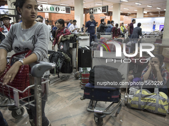 KATHMANDU, NEPAL-- April 29, 2015--  At the Kathmandu airport people waited for luggage at the baggage area which was full of incoming aid p...