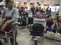 KATHMANDU, NEPAL-- April 29, 2015--  At the Kathmandu airport people waited for luggage at the baggage area which was full of incoming aid p...