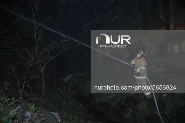 South Korean Fire fighters work to extinguish a blaze on a mountain in Andong, 268 kilometers southeast of Seoul, South Korea on April 26, 2...