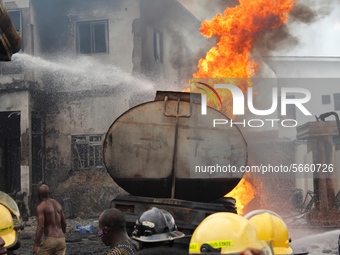 Firemen try to put out fire on a burning tanker at Ogba in Lagos. Amid Coronavirus (COVID-19) pandemic lockdown a fuel taker caught fire, bu...