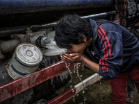 A kid is drinking water from the water -van at Tudikhel temporary shelter. Tudikhel, Kathmandu, 30th April 2015. The official death toll cli...