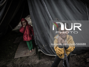 Kids are standing in front of his tent. Tudikhel temporary shelter, Kathmandu, 30th April 2015. The official death toll climbed to over 7,20...