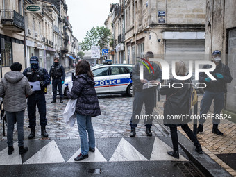 Police check people demonstrating for May Day in Bordeaux, France, on May 1, 2020 during lockdown. (