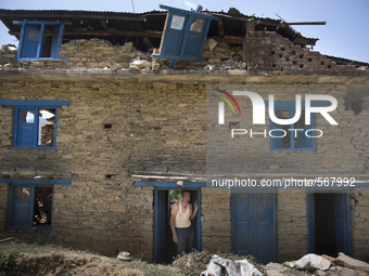SINDHUPALCHOK, NEPAL-- May 5, 2015--A man inside the doorframe of his heavily damaged house in a village on the road between Kathmandu and S...