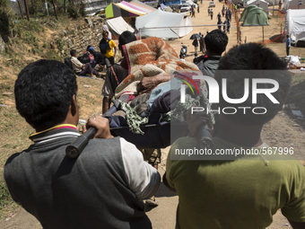 SINDHUPALCHOK, NEPAL-- May 5, 2015--People carry a woman on a stretcher towards a makeshift medical clinic in Sindhupalchok, a region which...