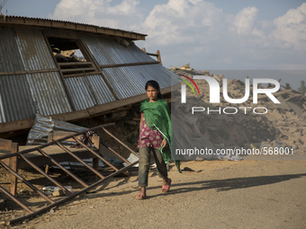 SINDHUPALCHOK, NEPAL-- May 5, 2015--A girl walks past a collapsed house in the village of Jalkeni on the road between Kathmandu and Sindhupa...