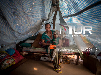Sumit Roy Achami has taken shelter with her child in a tent. Dhading, Nepal. May 5, 2015 (