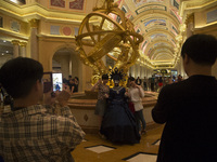 Tourist take pictures to a relative inside the Venetian Casino, Hotels and Resort in Macao, China, May 3 2015. (