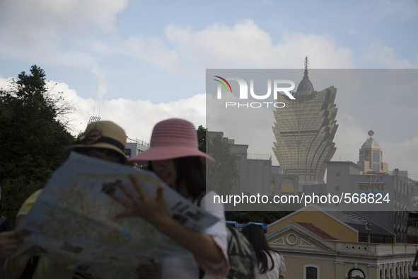 Tourist watching a map as the Gran Lisbona Casino and Hotel is seen from the Macao's hystoric center in Macao, China, May 2 2015. 