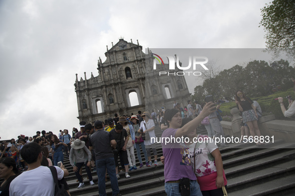 Tourist take selfie picture in front of the Ruin of St. Paul cathedral in Macao, China, May 2 2015. 