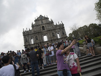 Tourist take selfie picture in front of the Ruin of St. Paul cathedral in Macao, China, May 2 2015. (