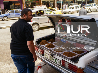 A tobacco seller  (the tobacco is put in the trunk of his car) in Hebron, Palestine, May 6th 2015.  (