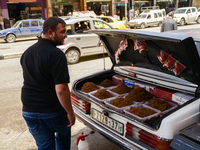 A tobacco seller  (the tobacco is put in the trunk of his car) in Hebron, Palestine, May 6th 2015.  (