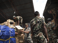 KATHAMNDU, NEPAL-- May 6, 2015--Nepalese Army teams prepare aid packages at the Kathmandu airport to be shipped by plane and helicopter to r...