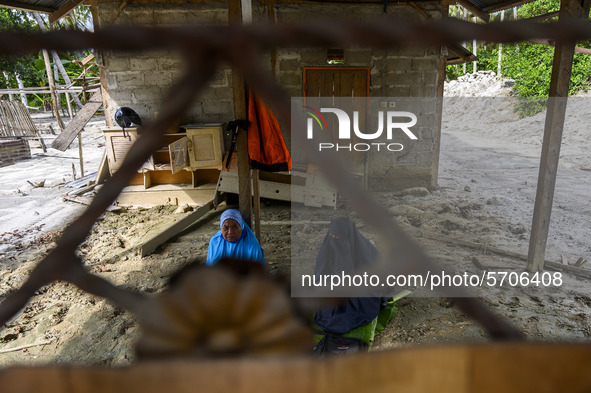 Residents reside in their homes damaged by flash floods in Poi Village, South Dolo Subdistrict, Sigi Regency, Central Sulawesi Province, Ind...
