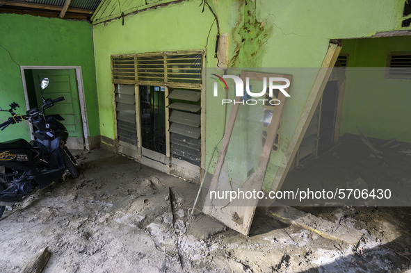 The condition of one of the houses that was heavily damaged and buried by mud due to flash floods in Poi Village, South Dolo Subdistrict, Si...