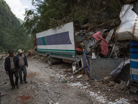 Men pass on the Kobani road as they look a damaged truck caused by the deadly earthquake near the Tibetan (Chinese) border.
Isolated Nepales...