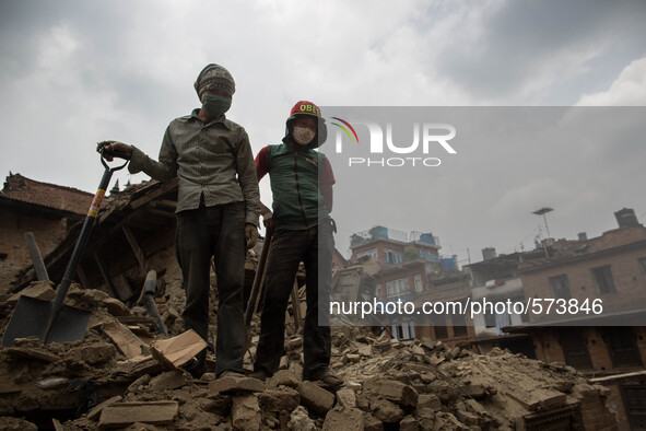 Nepalese Volunteers are pictured as they stand in the top of a mountain of rubble.
2 weeks after the powerful and deadly earthquake, a view...