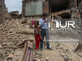 A man and her daughter are pictured as they are standing in the middle of the rubble where their house was before the earthquake.
2 weeks af...